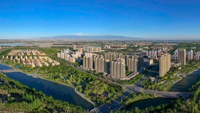 An aerial panoramic drone photo taken on May 9, 2024 shows a city view of Wujiaqu, northwest China's Xinjiang Uygur Autonomous Region.