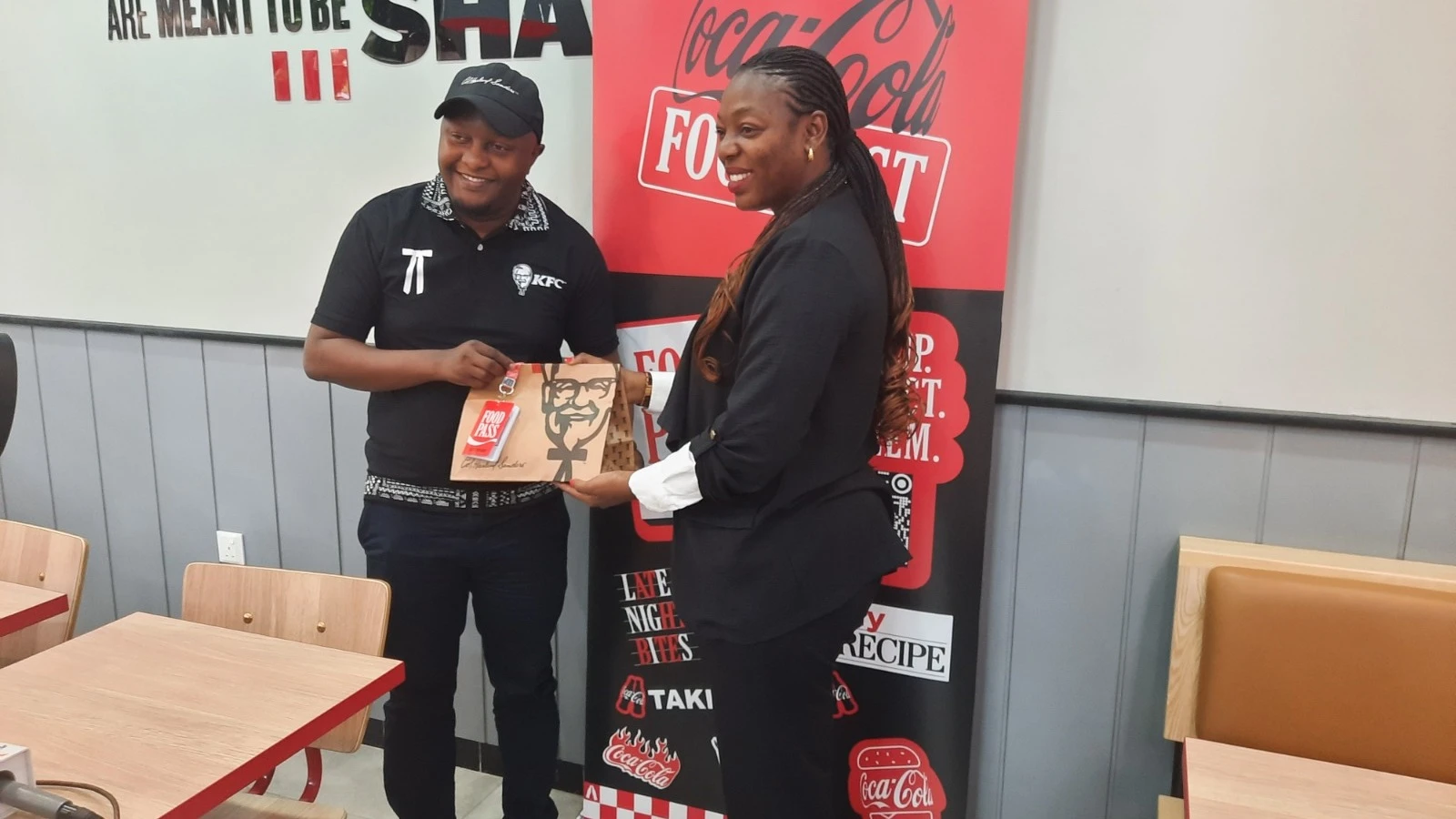 Kabula Nshimo, Meneja Mwandamizi wa Masoko wa Coca-Cola Tanzania (kulia), na Shafii Abbas Idege, Meneja wa Operesheni wa KFC Tanzania, wakiwa pamoja wakati wa uzinduzi wa Kampeni ya Food Pass kwa wateja wa KFC jijini Dar es Salaam. 