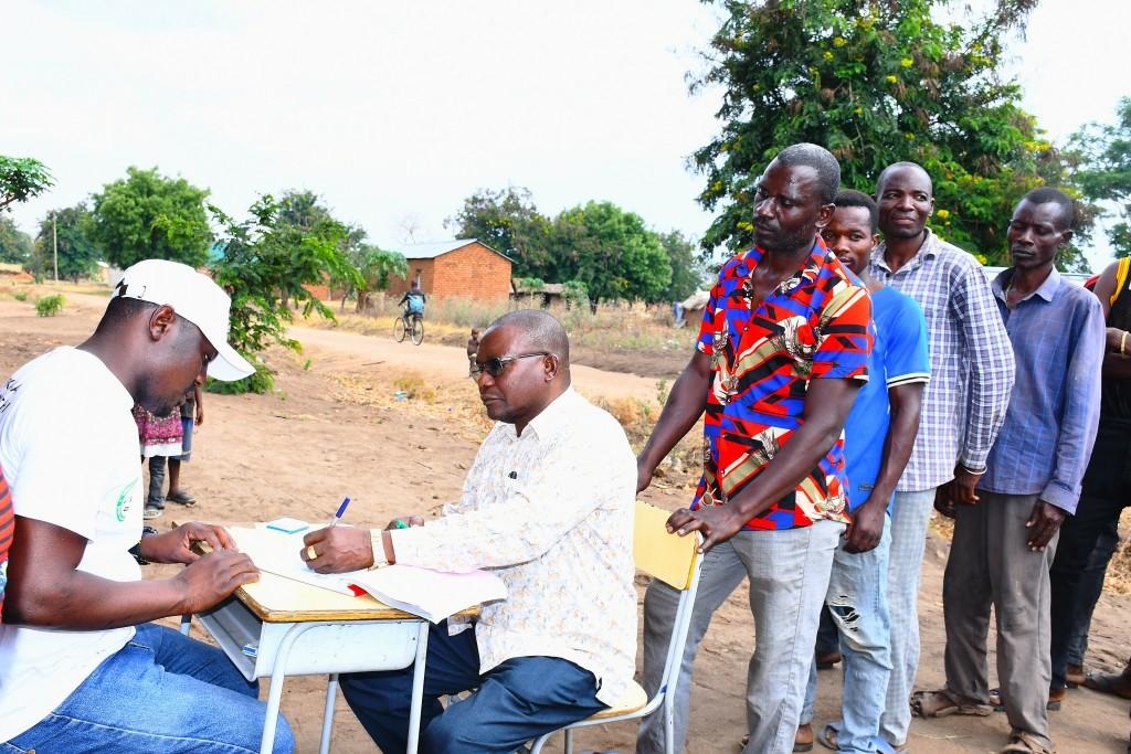  Kavuu constituency legislator Geophrey Pinda (2nd-L), who is Lands, Housing and Human Settlements Development deputy minister, registers in the national Permanent Voters’ Register at Ndemanilwa in Mpimbwe District, Katavi Region, 