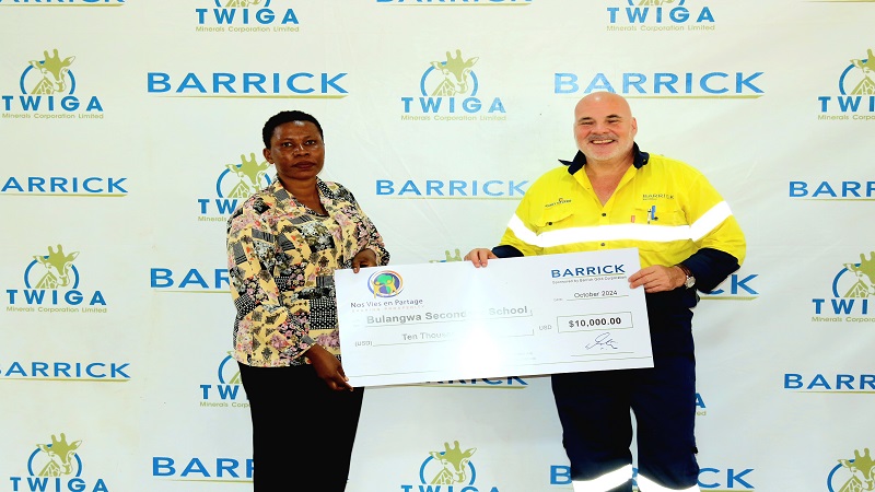  Barrick Bulyanhulu Mine’s acting general manager, Damian Brice Houseman (R), pictured at Bulyanhulu mine in Shinyanga Region at the weekend presenting a dummy cheque for US$10,000 to Bulangwa Secondary School headmaster Sane Machembe