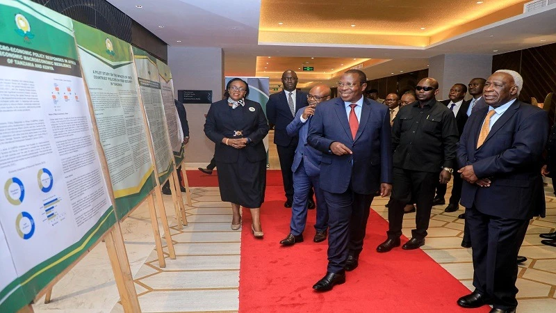 Vice President Dr Philip Mpango is briefed on a sample of research findings by the Economic and Social Research Foundation (ESRF) shortly before gracing the foundation’s 30th anniversary in Dar es Salaam yesterday. 