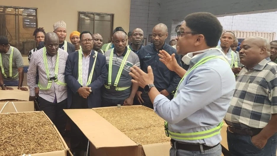 Alliance One sales representative Stephen Godfather (2nd R) explains a point to Uyui District Councilors during their guided tour of the factory in Morogoro yesterday.