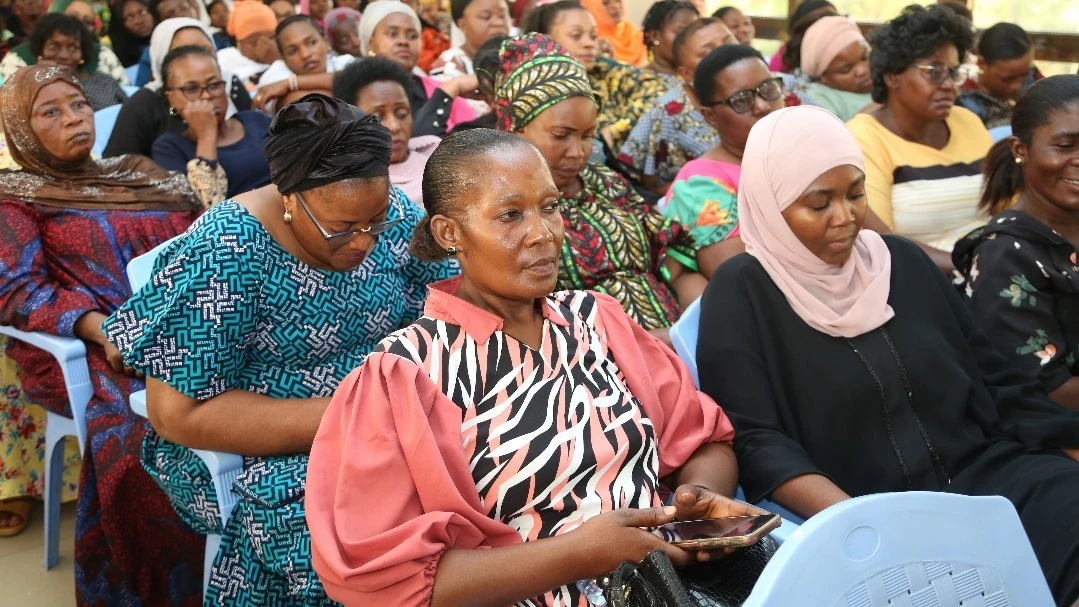 Women entrepreneurs in Dar es Salaam listen to Ilala District Commissioner Edward Mpogolo (not pictured) as he closes the three-day training program, offered by the College of Business Education (CBE).