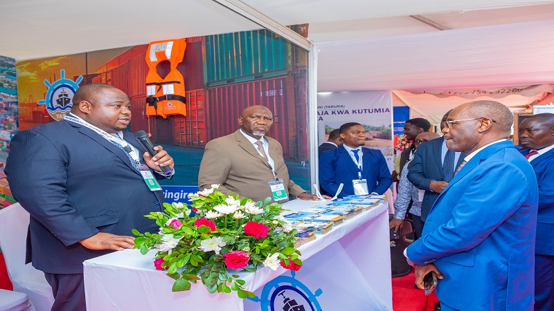 Tanzania Shipping Agency director general Mohamed Salum (L) briefs Transport minister Prof Makame Mbarawa (R), who visited the TASAC pavilion during the 17th Joint Transport Sector Review Meeting held in Arusha city yesterday.