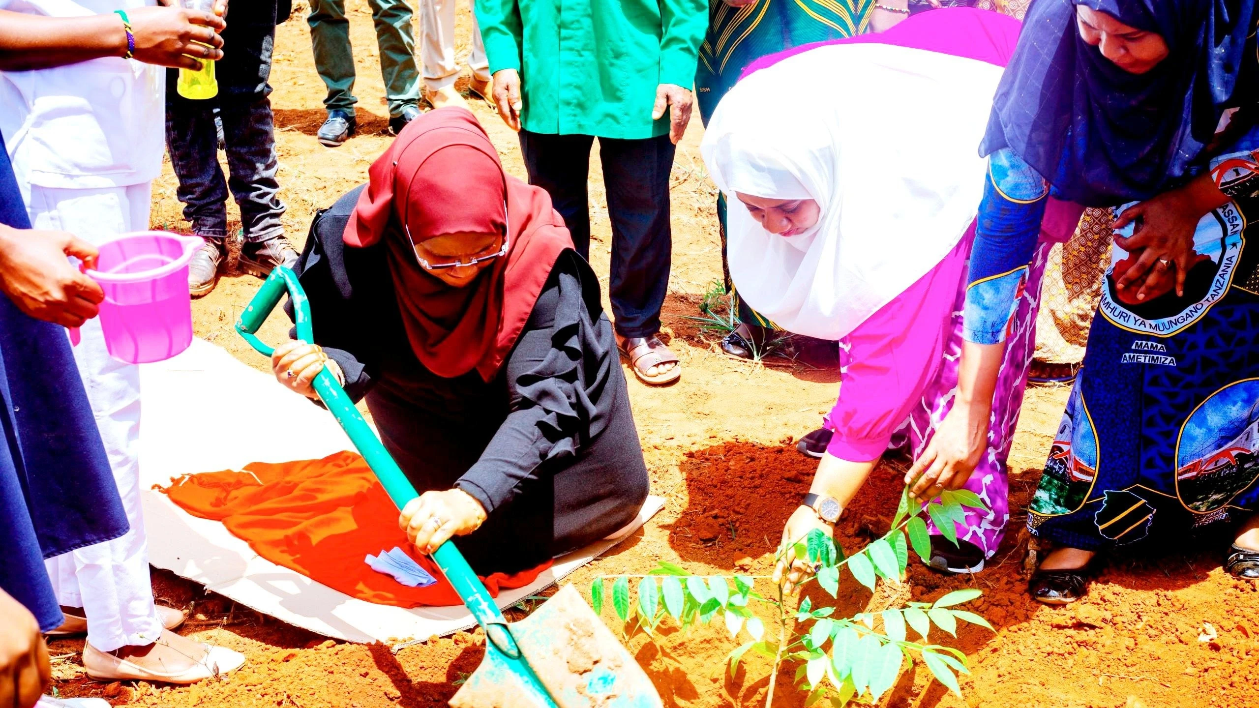 Dr Ashatu Kijaji (L), Minister of State in the Vice President’s Office (Union and the Environment), plants a tree at a Pangamlima village dispensary in Muheza District on Thursday shortly after laying the foundation stone for a building at the facility. 