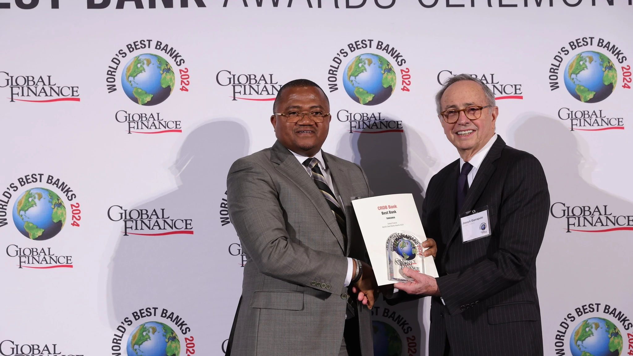 CRDB Bank's Group CEO, Abdulmajid Nsekela (L), receives the award for Best Bank in Tanzania from Joseph Giarraputo, Founder and Editor-in-Chief of Global Finance (R ), at the event held in Washington D.C. on Saturday.