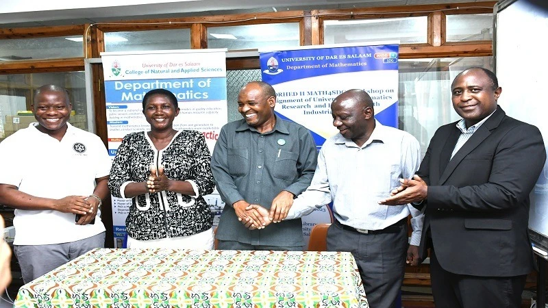 MAT Chairperson Dr. Said Sima (center) shake a hand with the Lecturer of the Mathematics Department at the University of Dar Salaam Dr Sylvester Ruheihyamu during the ceremony to announce the results of the national Mathematics winners .