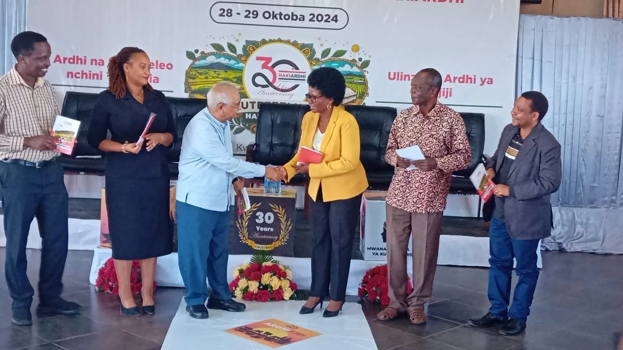 
Prof. Issa Shivji (L) shakes hands with Deputy Principal Secretary in the Ministry of Lands, Housing and Human Settlements, Lucy Kabyemera (R) after launching the Forum.