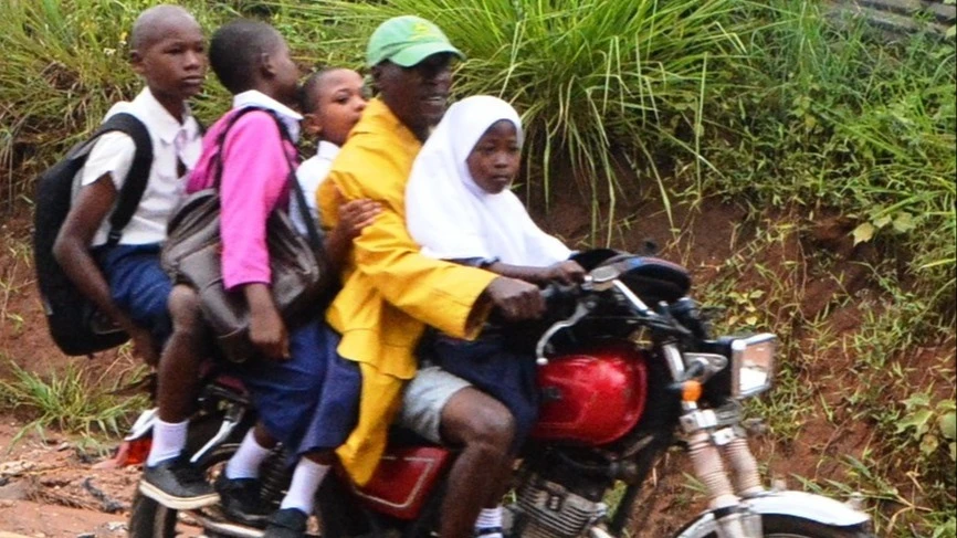 A motorbike rider carries four passengers, all of whom are without helmets, in Dar es Salaam recently, posing a danger to public safety. 