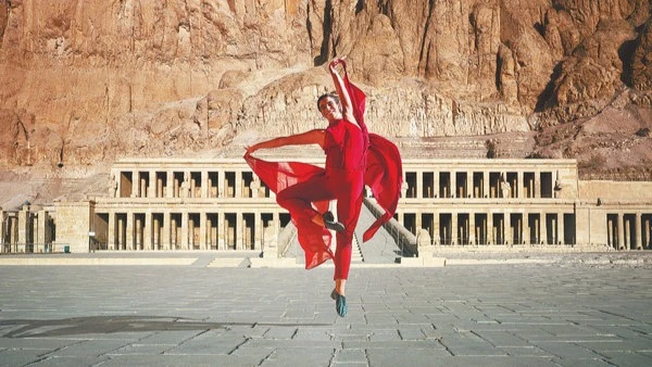 
A dancer takes to the air against the backdrop of an ancient Egyptian temple.