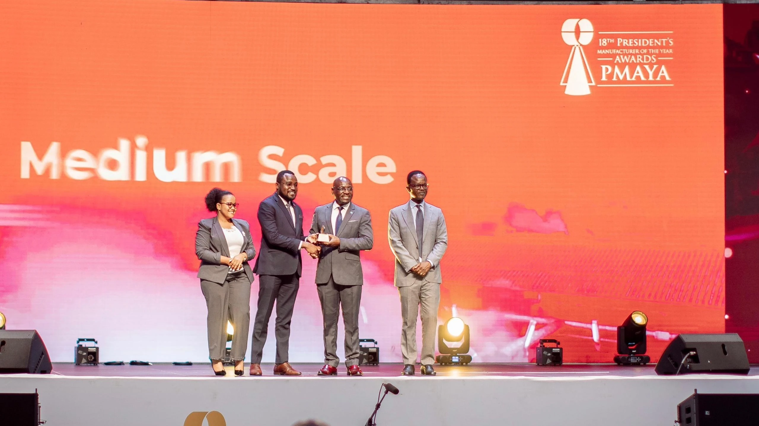 

Exaud Kigahe, the Industries and Trade deputy minister handing the President’s Manufacturer of the Year Award 2024 to Hillary Godson, Jubilee Life Chief Accountant. The company emerged the best life insurance provider under the Insurance category.