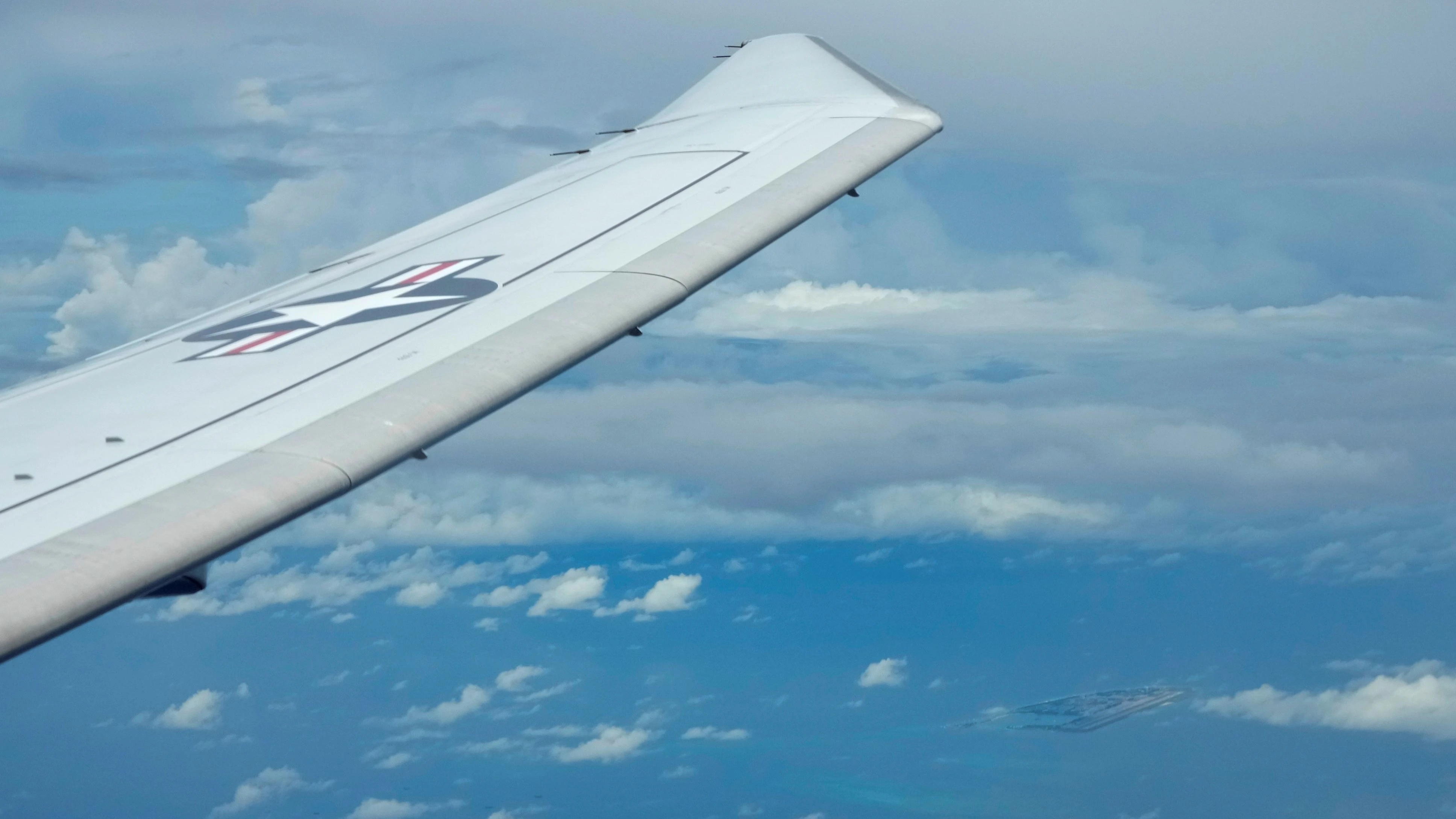 In this file photo dated March 20, 2022, a US P-8A Poseidon reconnaissance plane flies above the South China Sea. 