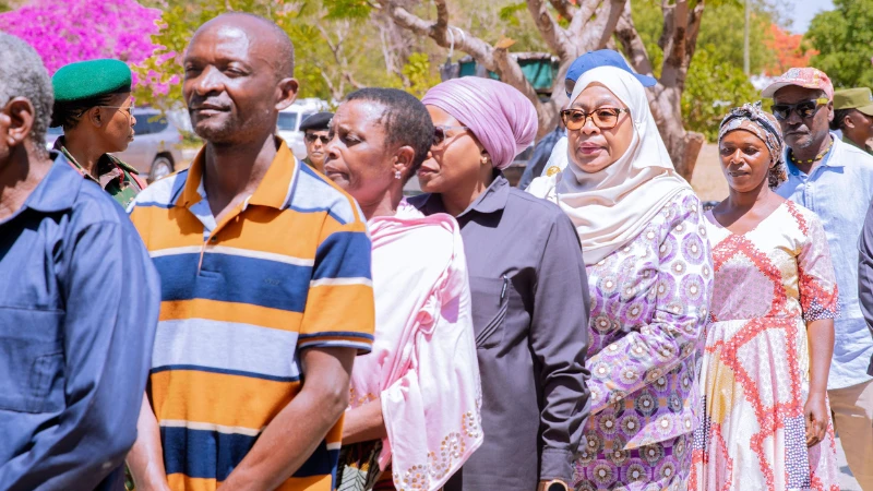 President Dr Samia Suluhu Hassan in a queue alongside other citizens as they line up to vote for local government leaders in the Sokoine hamlet, Chamwino District in the capital, yesterday.