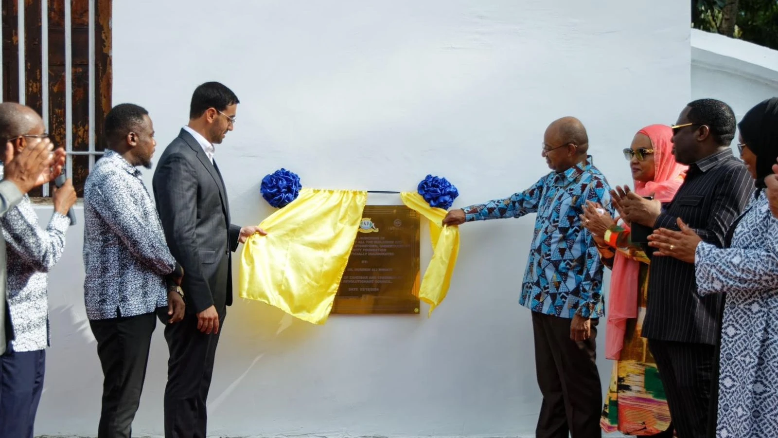 Zanzibar President Dr Hussein Mwinyi inaugurates the Stone Town repainting exercise on Wednesday. Left is Infinity Group Chairman Samuel Saba.