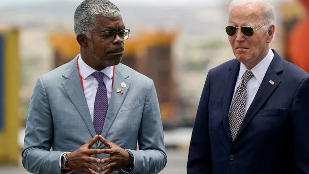 U.S. President Joe Biden stands with Angolan Minister of Transport Ricardo Daniel Sandao Queiros Viegas de Abreu, during a visit to the Lobito Port Terminal to receive a briefing on the Lobito Atlantic Railway, in Lobito, Angola, December 4, 2024. 