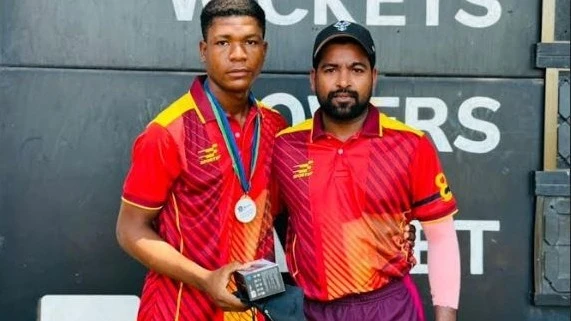 Aces A cricket team's youthful performer Hamza Ally (L) receives the Player of the Match prize from teammate Abhishek Kumar after the squad faced Delaware Upanga SC in the 2024 Tanzania Cricket Association (TCA) Delaware Champions League.