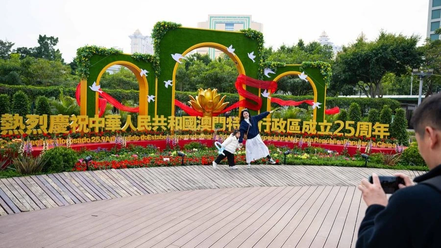 People visit a flower show on Taipa Island in Macao, south China, Dec. 14, 2024. A flower show celebrating the 25th anniversary of Macao's return to the motherland kicked off here on Saturday and will run until Jan. 5, 2025.