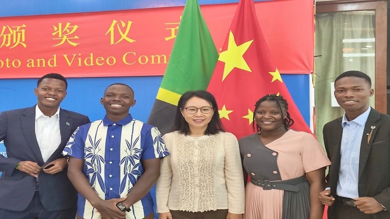 Chinese Ambassador to Tanzania, Chen MingJian (C), poses for a group photo with participants of the China-Tanzania Friendship Photo and Video Competition during the recent award ceremony held at the Chinese Embassy in Dar es Salaam.