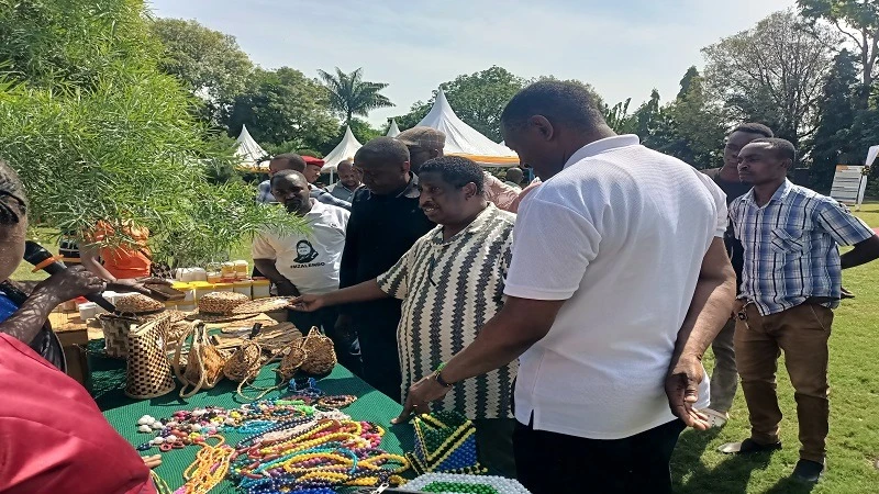 Kilimanjaro regional commissioner Nurdin Babu (2nd-R) views various home-made cultural items as well as medicinal leaves, seeds, roots, representing the skills of Kilimanjaro Region. 