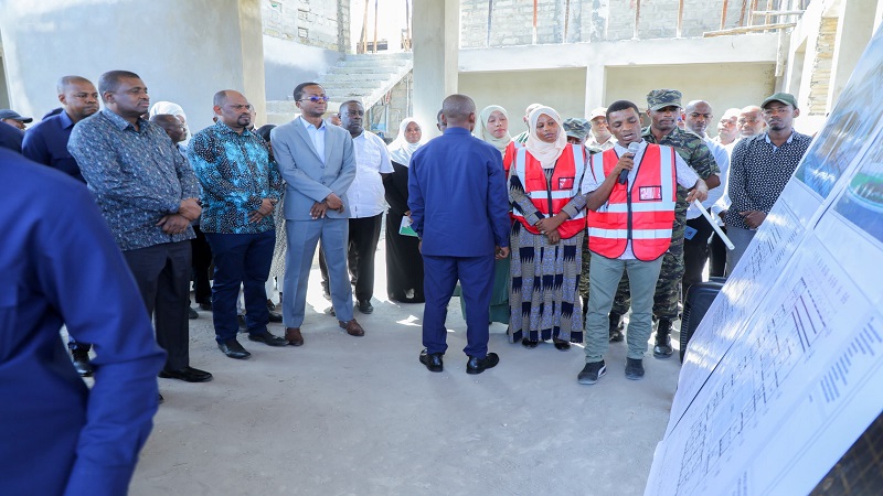 Zanzibar’s Second Vice President, Hemed Suleiman Abdulla (L), is briefed when gracing the laying of the foundation stone for Kiuyu Minungwini Health Centre in the North Pemba Region yesterday. 