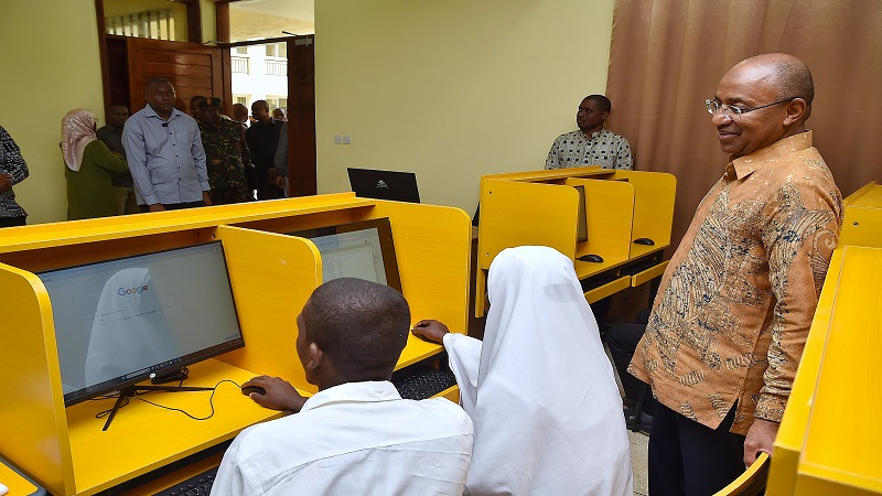 DR MWINYI Zanzibar President Dr. Hussein Ali Mwinyi looks at Tumbatu Secondary School students Hussein Aboud and Nassra Ali   using computers in education  shortly after inaugurating  the school as part of 61st anniversary of Zanzibar Revolution.