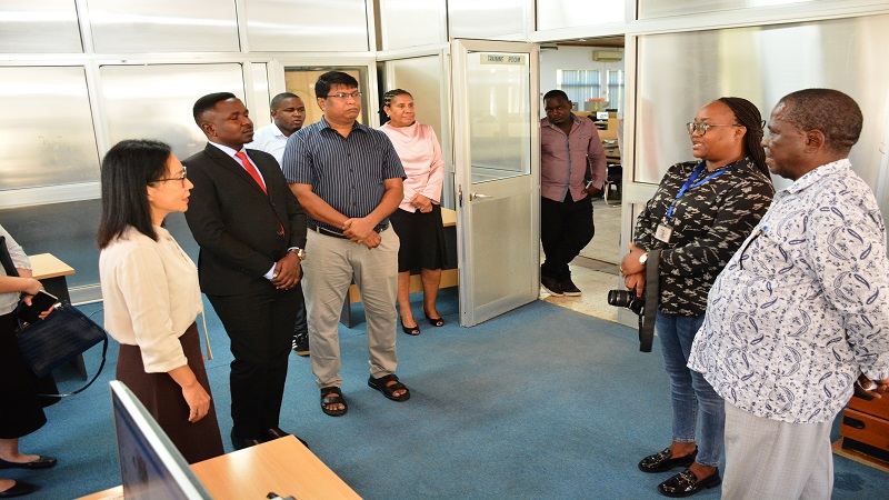 	Ambassador Chen (L) gets briefing at TGL digital section  News Reporter  Mary Kadoke. 