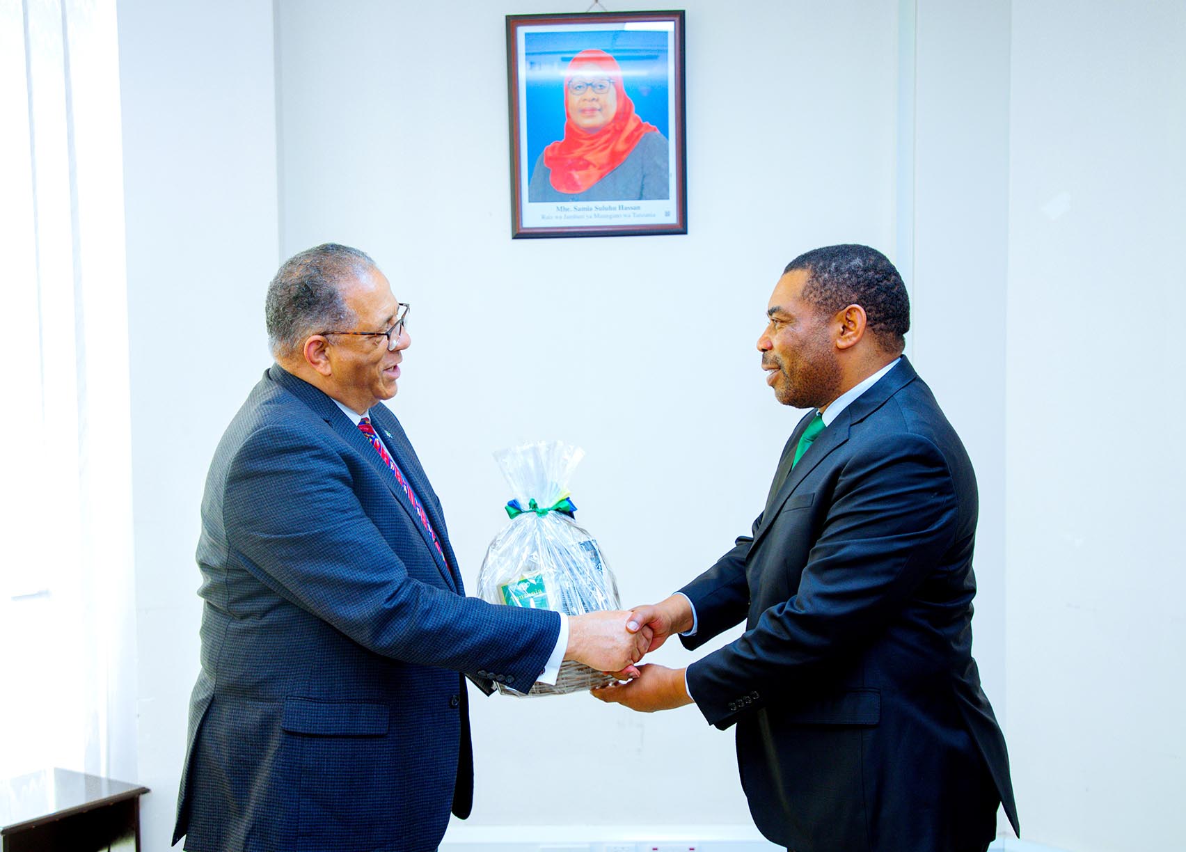 Minister for Finance, Dr. Mwigulu Nchemba (R), bids farewell to the outgoing U.S. Ambassador to Tanzania, Michael Battle, shortly after their meeting in Dodoma yesterday