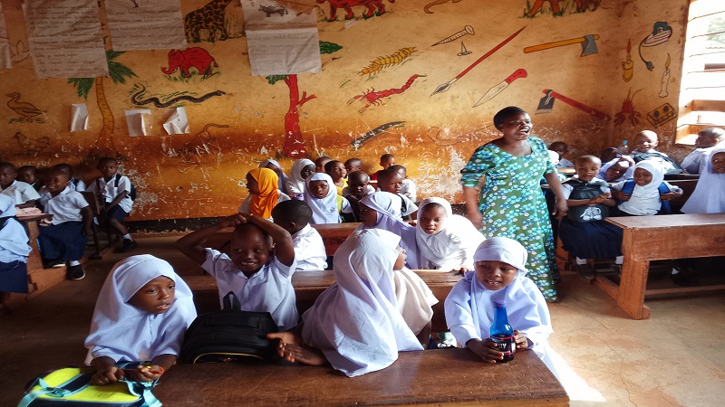 Mariam Hamza, a Standard One teacher at Mdote Primary School in Muheza District, Tanga Region speaks with pupils starting schooling yesterday