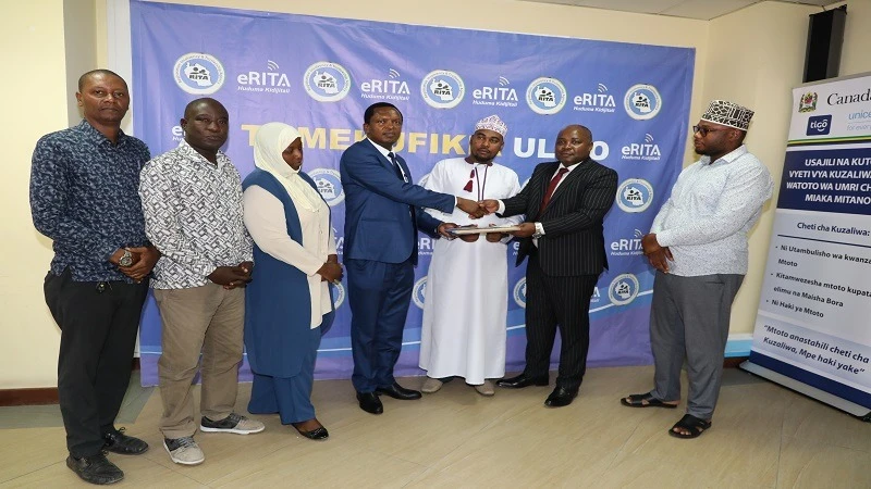 RITA Chief Executive Officer Frank Kanyusi (2nd L) receives investigation report on assets of Manyema Mosque from Chairman of the committee, Alex Maleva (4th L) in Dar es Salaam yesterday, witnessed by clerics from the region. 