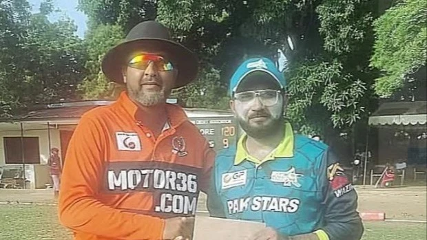 Pak Stars A's Mohamed Ali (R) receives the Player of the Match prize from a match umpire upon the conclusion of the 2024 Tanzania Cricket Association (TCA) DC Super League tie pitting the team against Patel Brotherhood A in Dar es Salaam recently. 