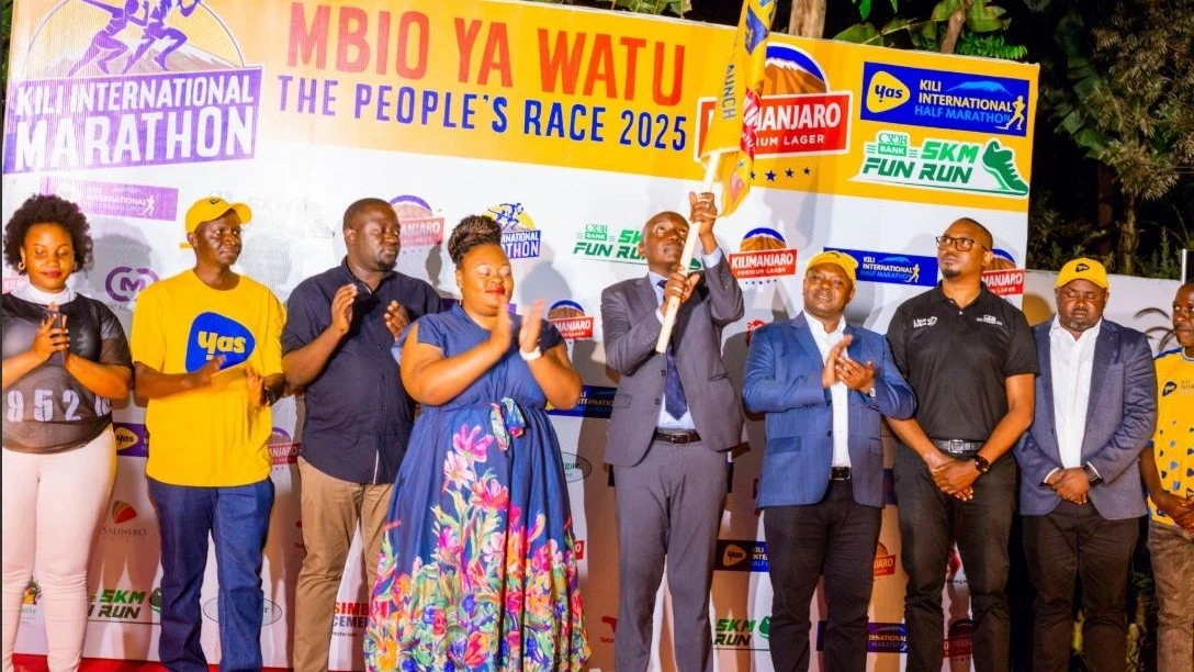 The Kilimanjaro Regional Administrative Secretary, Kiseo Yusuf Nzowa, waving the flag to officially launch the Kilimanjaro Premium Lager International Marathon 2025 in Moshi on Friday  as sponsors and other stakeholders look on