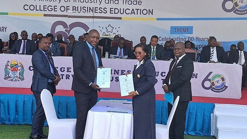 College of Business Education Rector Prof Edda Lwoga (2nd R) and Business Registration and Licensing Agency CEO Godfrey Nyaisa show documents shortly after signing an agreement on collaboration in business training between the two institutions .