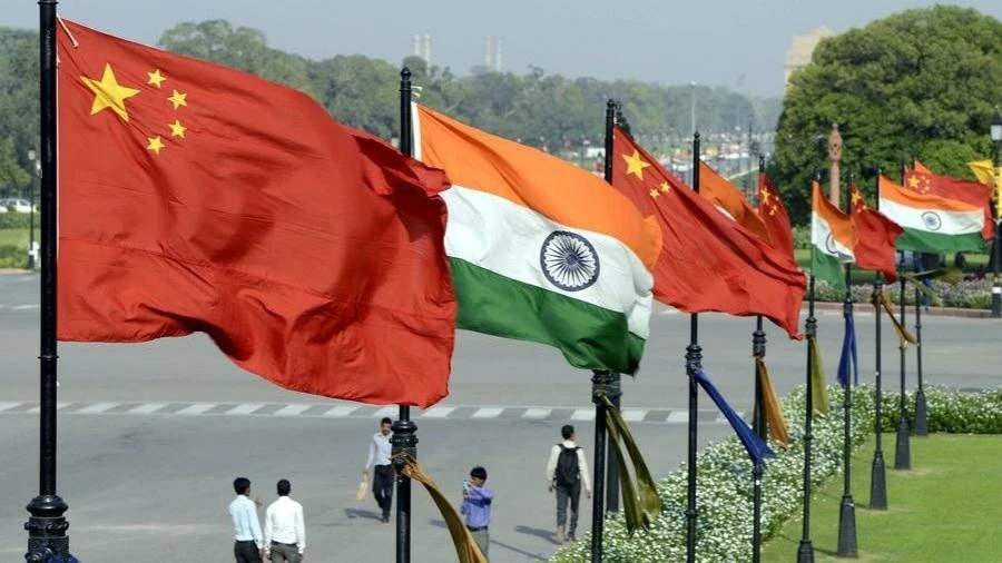 In this undated file photo, Indian and Chinese national flags flutter side by side at the Raisina hills in New Delhi, India.