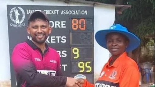 Aga Khan SC's Abhik Patwa (L) gets the Player of the Match prize from match umpire Monica Iddi after the club's 2024 Tanzania Cricket Association (TCA) DC Super League clash against Patel Brotherhood A in Dar es Salaam recently.