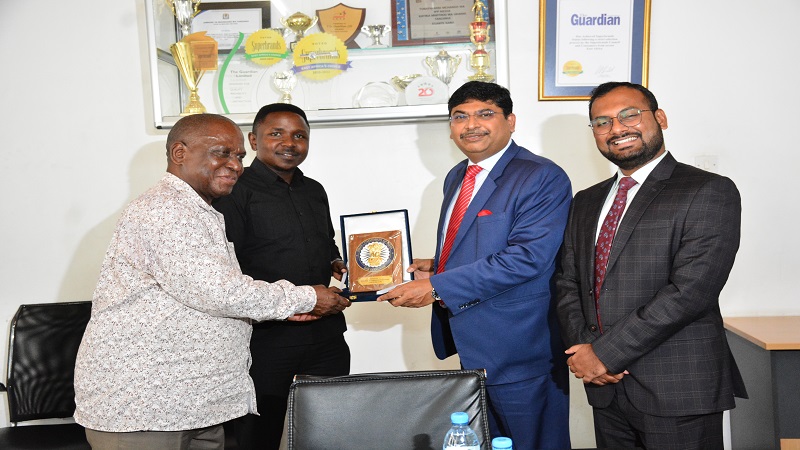 TGL Deputy General Manager Jackson Paul (2nd L) and The Guardian newspaper Managing Editor Wallace Mauggo (L) receive gifts from High Commissioner Bishwadip Dey. Right is the High Commission's Head of Political Affairs, Lakshay Anand.