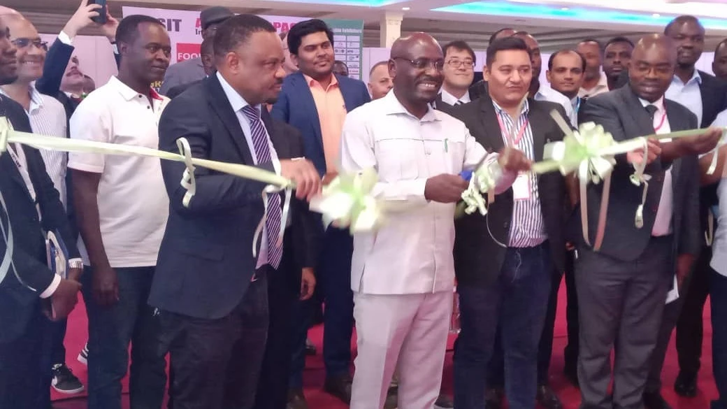 Deputy Minister for Trade and Industry, Exaud Kigahe cutting a ribbon to officiate the opening of the 9th Agro Food Packaging International Trade Exhibition