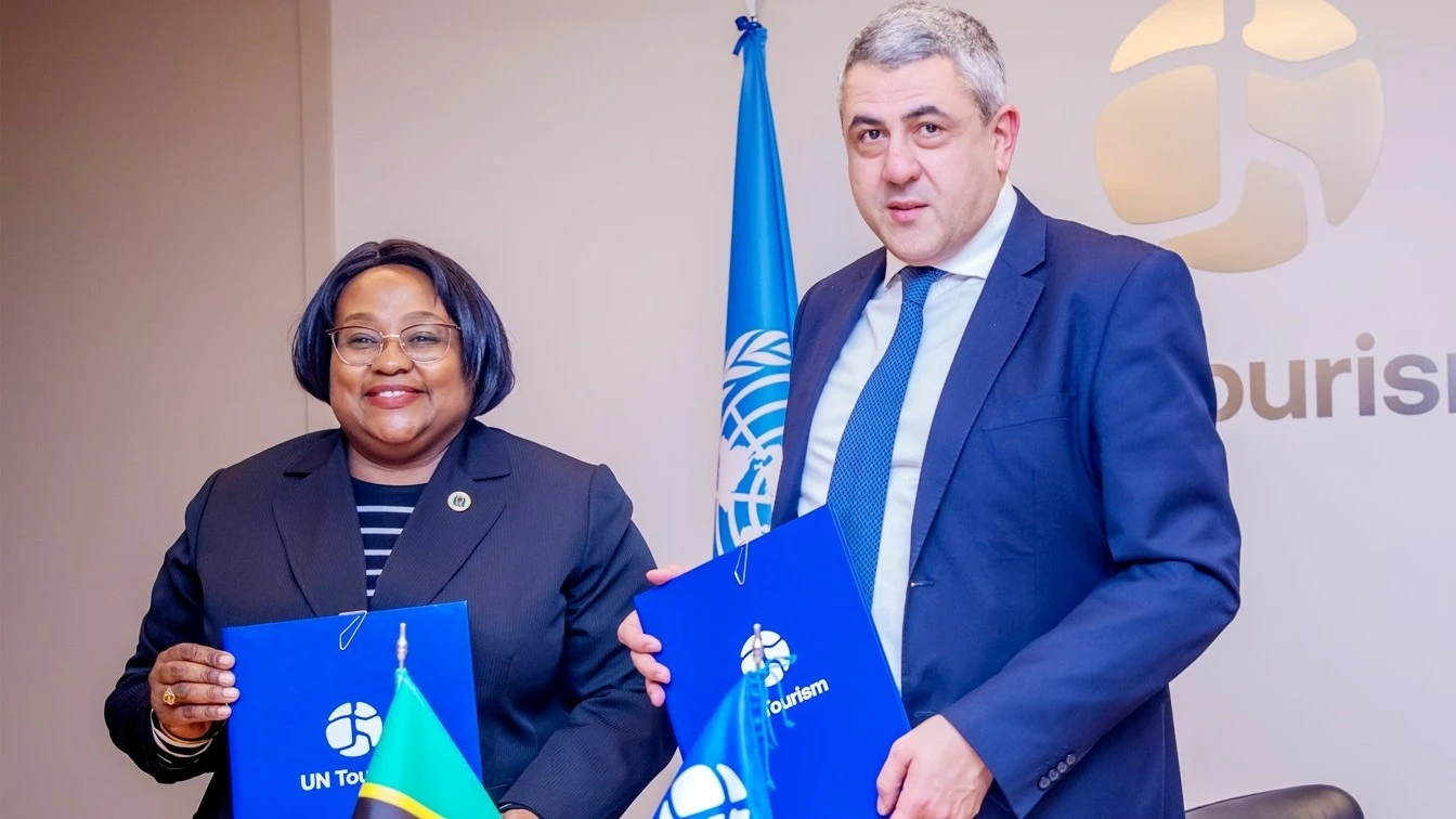 Dr Pindi Chana (L), the Natural Resources and Tourism minister, and the UN Tourism director general Zurab Pololikashvili, showcasing the contract documents for Tanzania to host the 2nd UN Tourism regional forum on gastronomy tourism for Africa.