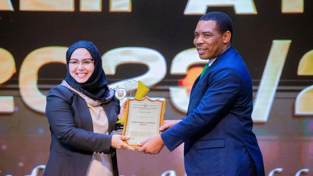 Finance Minister, Mwigulu Nchemba (right), presenting the best taxpayer of the year award to the Managing Director of Puma Energy Tanzania, Fatma Abdallah (left). The company excelled by receiving four awards which were issued by the TRA