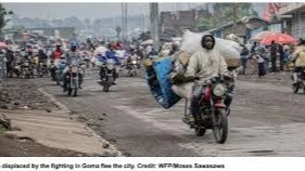 People displaced by the fighting in Goma flee the city.