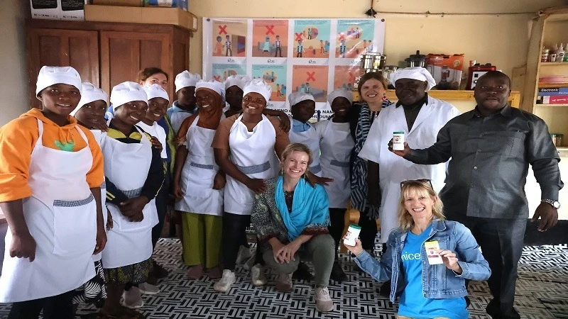 UNICEF HQ and UNICEF Tanzania gender experts with Integrated Programme for Out-of-School Adolescents (IPOSA) girls, who have been equipped with cooking and hospitality skills.