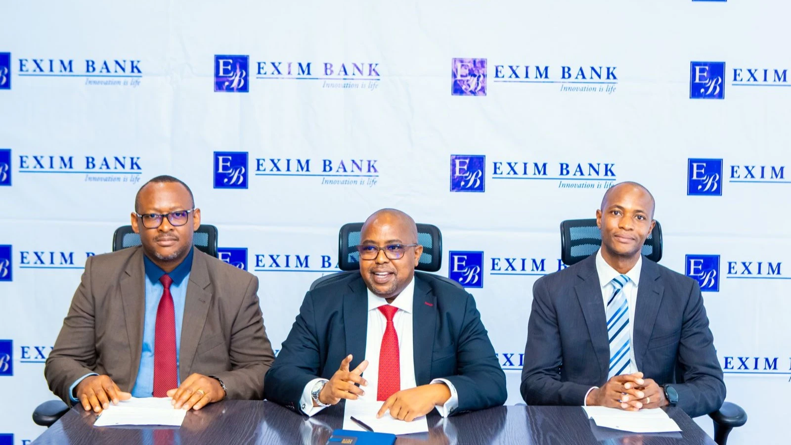 Exim Bank CEO Jaffari Matundu presents the 2024 Financial Report, highlighting strong growth, alongside Andrew Lyimo and Shani Kinswaga at the bank's headquarters in Dar es Salaam.