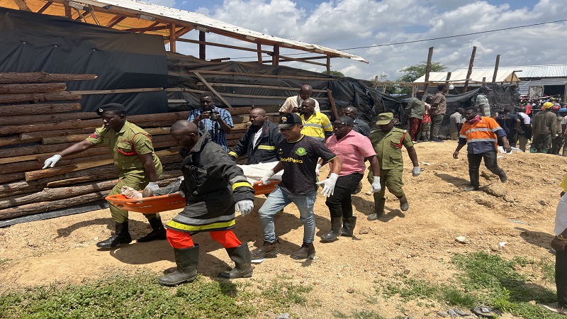 Fire and Rescue Force officers carry the body of one of the three small-scale miners who were reportedly trapped by a landslide while working at Nkandi mine at Ilindi-Mwine Street Zongomela ward in Kahama District Shinyanga re-gion 