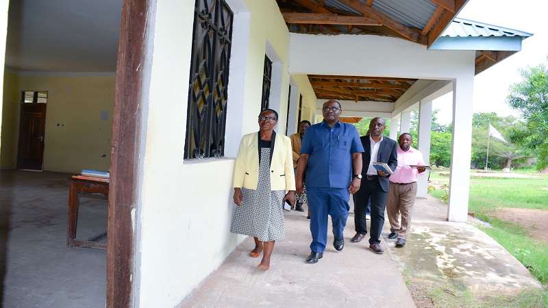 Tanzania Education Authority board chairman Dr Leonard Akwilapo (2nd-L) makes an inspection tour of progress in the construction of the Administration building at Lupaso Secondary School in Masasi District yesterday. 