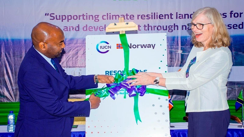 Hamad Masauni, Minister of State in the Vice President’s Office (Union and the Environment), cuts the ribbon in Dodoma city yesterday to launch a project the International Union for Conservation of Nature (IUCN) is implementing as part of a strategy.