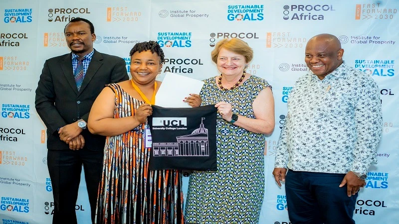 Prof. Henrietta Moore, director of the Institute for Global Prosperity hands over a certificate to one of the   scientists from Dar es Salaam during the launch of the Maisha Bora Index. 