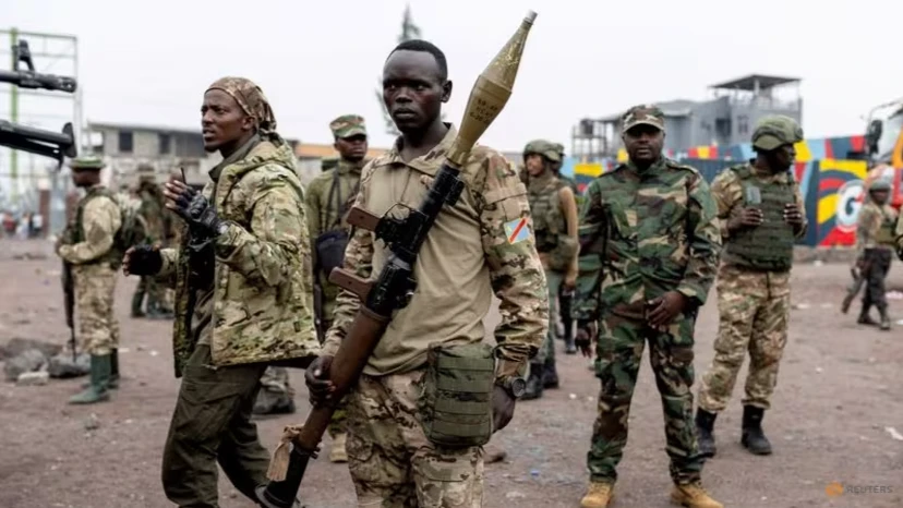 Members of the M23 rebel group gather to supervise Congolese potential recruits for the M23 rebel group before being taken to training centres run by M23 rebels, amid clashes between M23 rebels and the Armed Forces of the DRC.