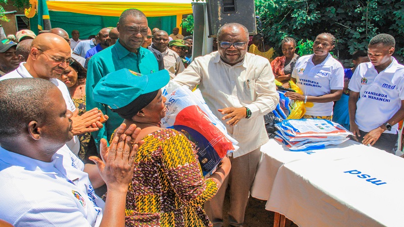 Shinyanga regional commissioner Anamringi Macha (3rd-R) pictured at the weekend presenting residents of the region with insecticide-treated mosquito nets issued by the government as part of a drive to combat malaria. 