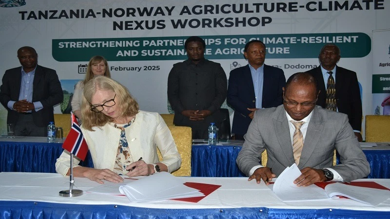 AGRA Regional Head for Eastern and Southern Africa Dr. Jean Jacques Muhinda ( R) and Norwegian Ambassador to Tanzania Tone Tinnes (L ) sign a partnership agreement at the Agriculture- Climate Nexus Workshop held recently in Dodoma.