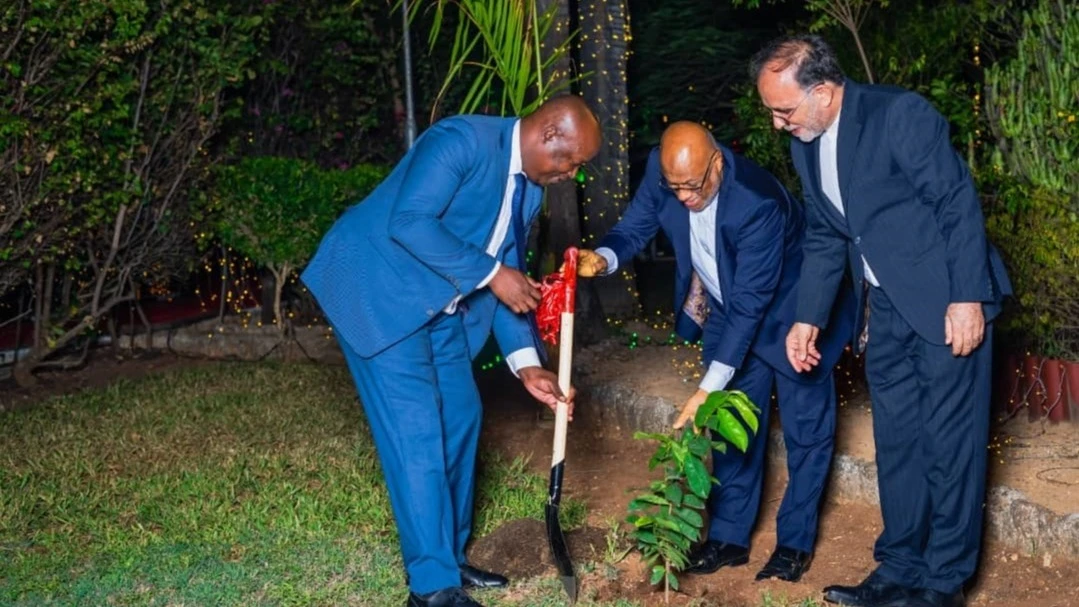 Dennis Londo, Foreign Affairs and East African Cooperation Deputy minister (East Africa Cooperation) (L), plants a tree in marking the 46th anniversary of Iran’s National Day. 