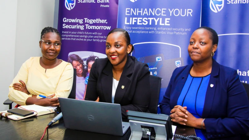 Stanbic Bank Tanzania's Card Issuing Manager, Irene Mutahibirwa (centre), announces the winners of the first draw of the Stanbic Tap Kibingwa campaign, where a total of five winners each received a prize of TZS 500,000.